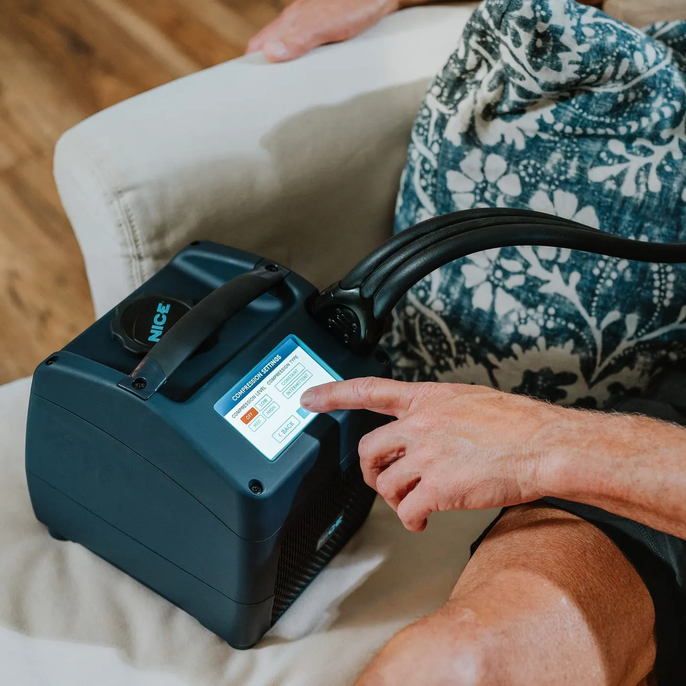 The NICE1 cold + compression unit, touchscreen, hose and wrap