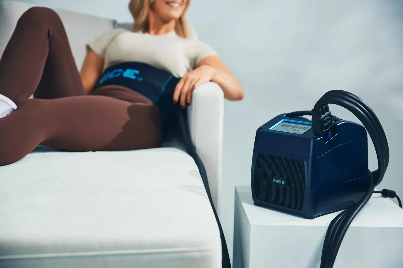 The NICE1 running a knee session at home, wrap fitted, unit beside the chair